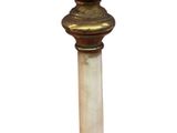 a gold pedestal with a marble top on a white background