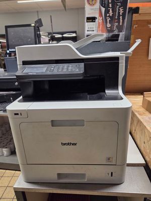 a white printer sitting on top of a counter in a store