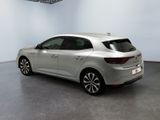 the rear end of a silver car in a white room