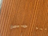 a close up of a wooden table with a mirror on it