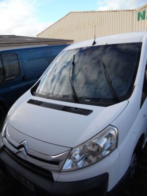 a white van that is parked next to a blue van
