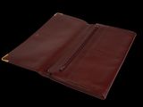 a close up of a brown leather wallet on a black background