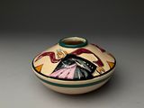 a small bowl with a painting on it on a table