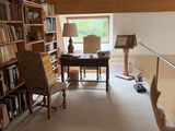 an image of a living room with a lot of books on the shelves