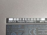 a label on the back of a laptop with a barcode on it