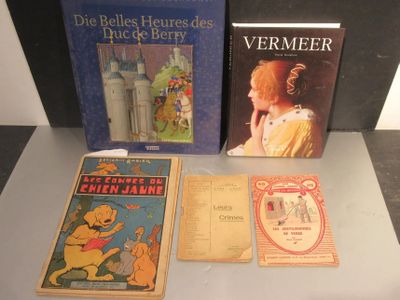 three books on a table with a picture of a woman in a yellow dress