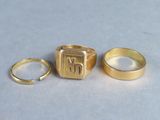 two gold rings and a gold ring with the letter m on it