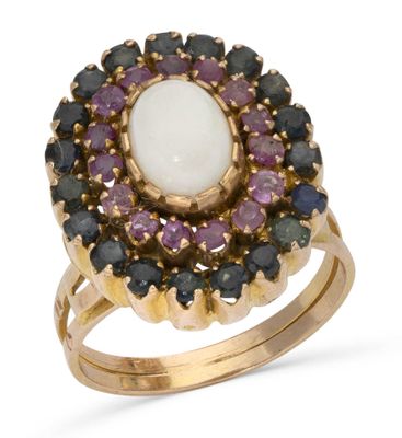 a close up of a ring with a white stone surrounded by purple and black stones