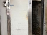 an image of an old refrigerator in a dirty room