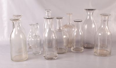 a lot of glass bottles that are sitting on a table