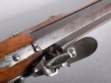 an old rifle with a wooden handle and a metal latch