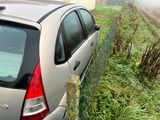 a car that is parked next to a fence