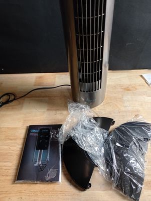 a fan sitting on a wooden table next to a cd