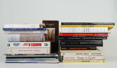 many books stacked on top of each other on a table