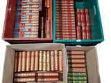 Des cartons remplis de livres sont empilés les uns sur les autres sur une surface blanche