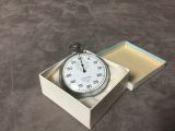 a stopwatch sitting in a box on the floor