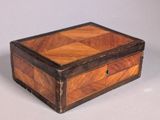 an old wooden box sitting on top of a white surface