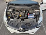 the engine of a car with its hood open in a parking lot