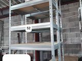 five shelves in the middle of a room with a lot of shelves on them