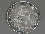 a close up of a silver coin with a woman ' s head on it