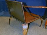 a chair that is sitting in front of a blue wall