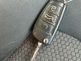a picture of a car key on the seat belt of a car