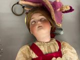 a doll that is laying on the floor next to a pair of scissors