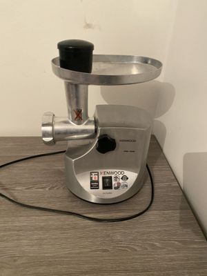 a silver and black blender sitting on a wooden table