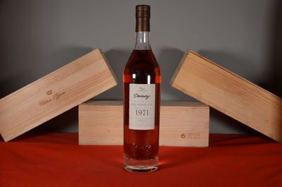 a bottle of wine sitting on a table next to a box