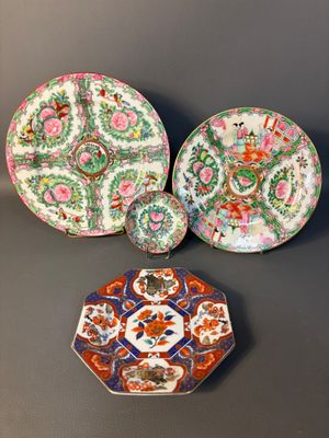 three chinese plates and a small plate on a table
