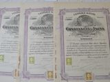 two old certificates are sitting on a white sheet on a table