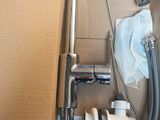 a box with a faucet and a hose in it