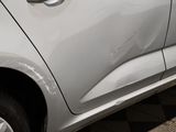 a close up of a car with a denting on the side of it
