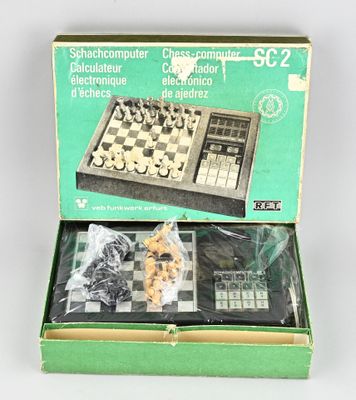a box with a chess set in it on a table