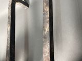 pair of antique iron hooks on a white background