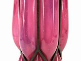 purple glass vase with a black metal base on a white background