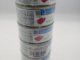 four cans of canned food stacked on top of each other