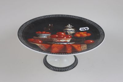 a plate with a picture of tomatoes on it on a stand