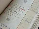 an open book with writing on it sitting on a table