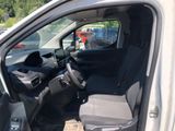the interior of a car with the door open and the driver ' s seat down