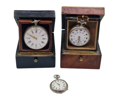two clocks that are sitting in a wooden box