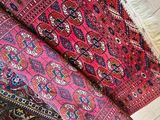 a pile of oriental rugs sitting on top of a wooden floor
