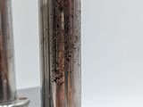 a metal object that has some dirt on it