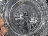 someone is holding a crystal vase with a clock on it