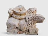a stone sculpture of a sheep and a lion on a white background