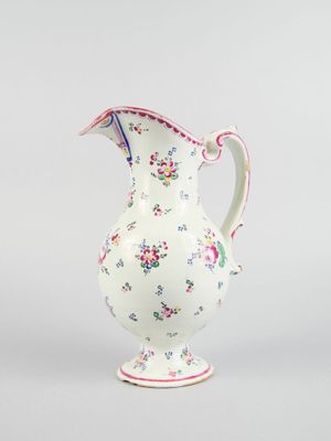 a white vase with a floral design on it