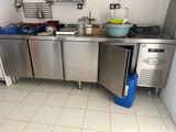 a stainless steel kitchen with a sink and a dishwasher