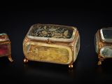 three pieces of jewelry sitting on top of each other on a black surface