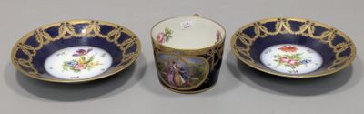 two cups and a saucer sitting on top of a table