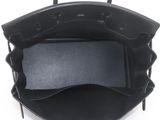 the inside of a black purse with a black handle